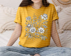 Black and white floral graphic T-shirt from Anchored Grace Boutique featuring a stylish flower print design.