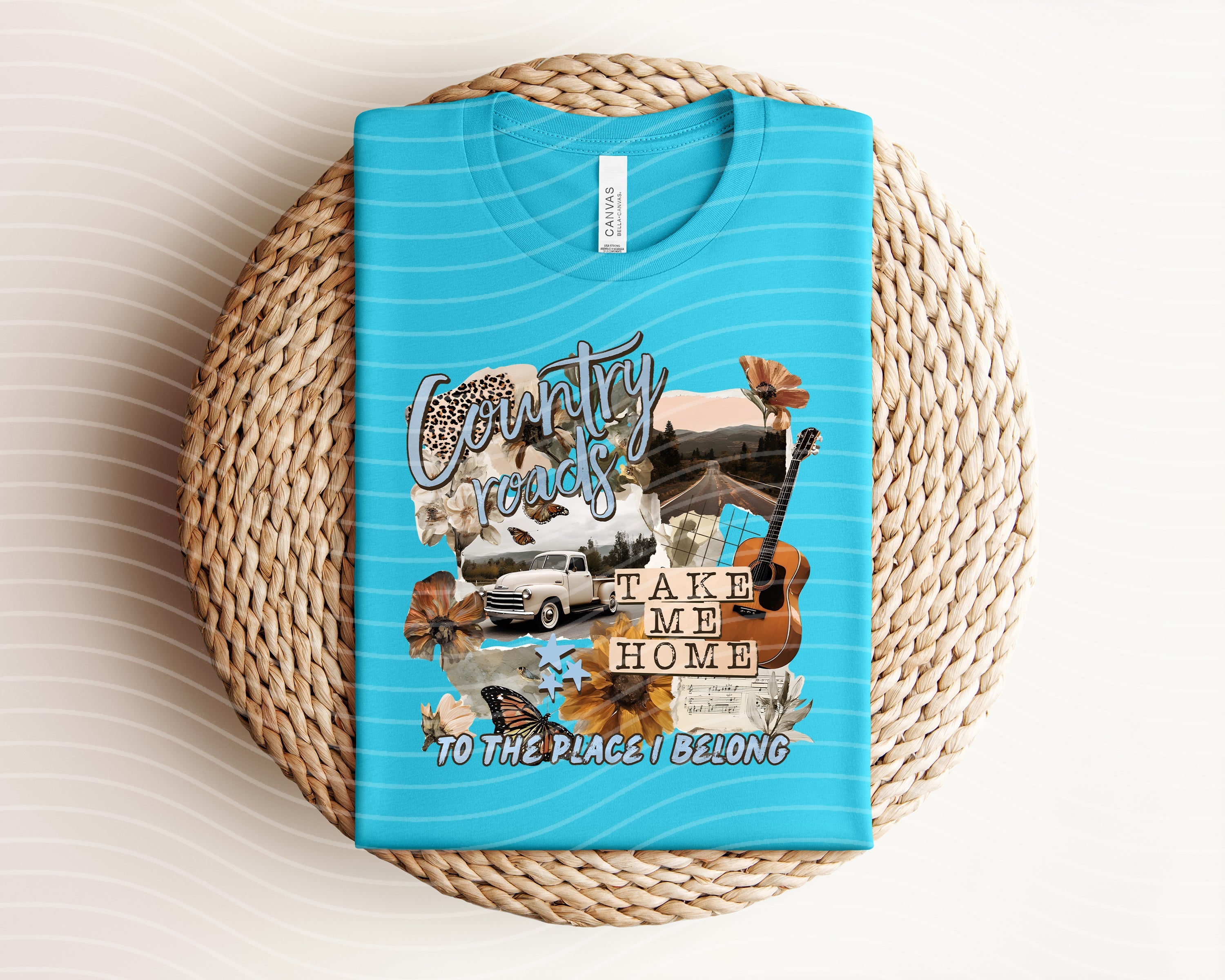 Country Roads Take Me Home graphic tee by Anchored Grace Boutique, featuring a scenic country road design on a casual t-shirt.