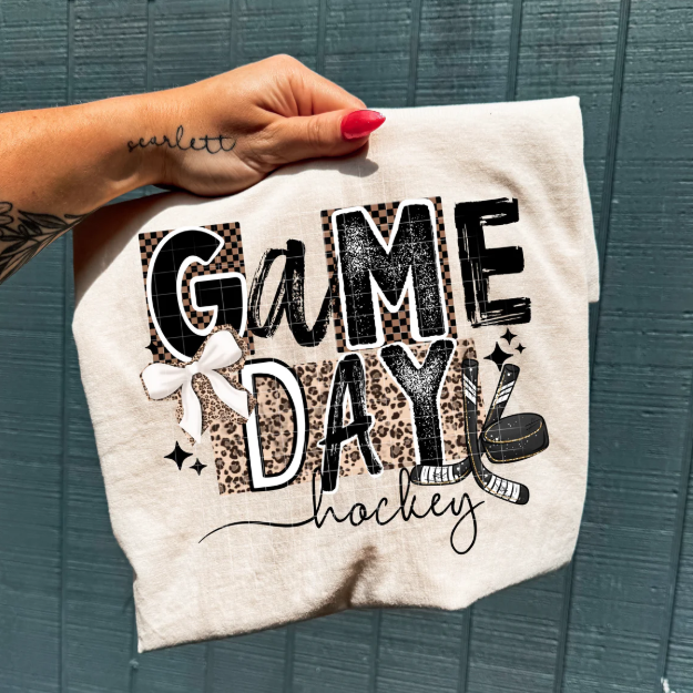 Black Game Day Hockey graphic tee by Anchored Grace Boutique featuring bold hockey-themed design on soft cotton fabric.