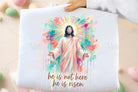 Christian graphic tee featuring "He is Not Here He is Risen" design by Anchored Grace Boutique, casual men's or women's T-shirt.