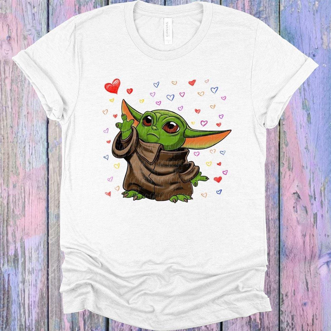 Hearts Alien graphic tee from Anchored Grace Boutique featuring colorful alien and heart illustrations on a casual cotton t-shirt.