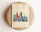 Hogwarts Christmas graphic tee by Anchored Grace Boutique featuring festive Harry Potter-themed design on a casual tee shirt.