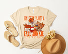 Anchored Grace Boutique's Fall Junkie graphic tee featuring autumn-themed design on a casual short-sleeve shirt.