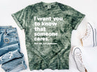 Black graphic tee by Anchored Grace Boutique with uplifting "I Want You to Know That Someone Cares" message in white text.