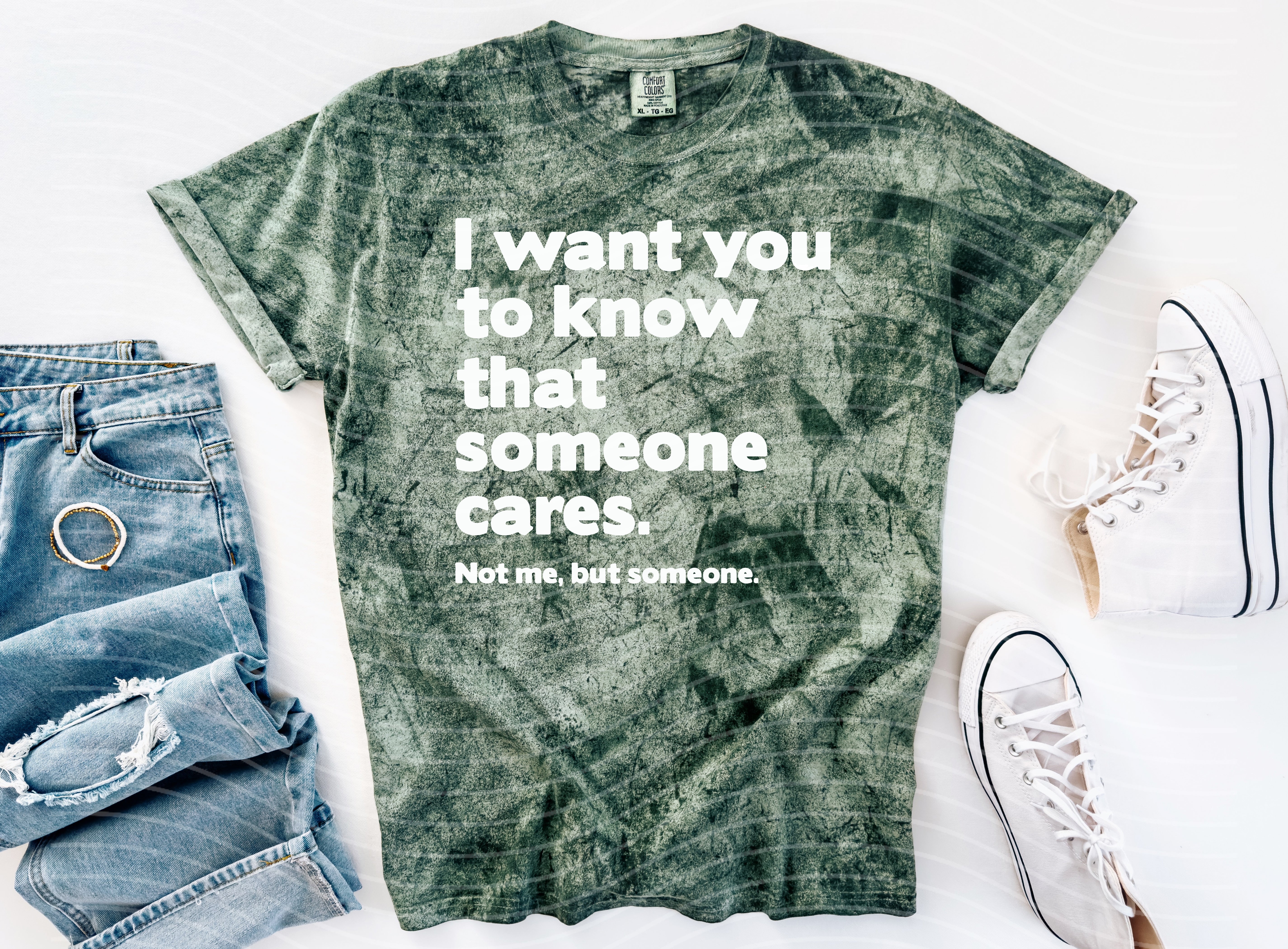 Black graphic tee by Anchored Grace Boutique with uplifting "I Want You to Know That Someone Cares" message in white text.