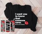 Black graphic tee from Anchored Grace Boutique with white text that says "I Want You to Know That Someone Cares."