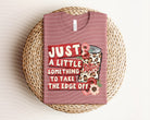 Anchored Grace Boutique graphic tee featuring a design with the phrase "Just a Little Something to Take the Edge Off" on soft cotton fabric.