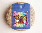 Anchored Grace Boutique Lisa Frank Obsessed graphic tee featuring colorful Lisa Frank design on a casual t-shirt.