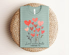 Black Love Never Fails graphic tee by Anchored Grace Boutique featuring white inspirational text on the front.