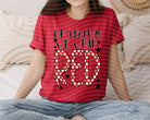 Red graphic tee from Anchored Grace Boutique with "On Fridays We Wear Red" slogan, casual fit, and stylish design.