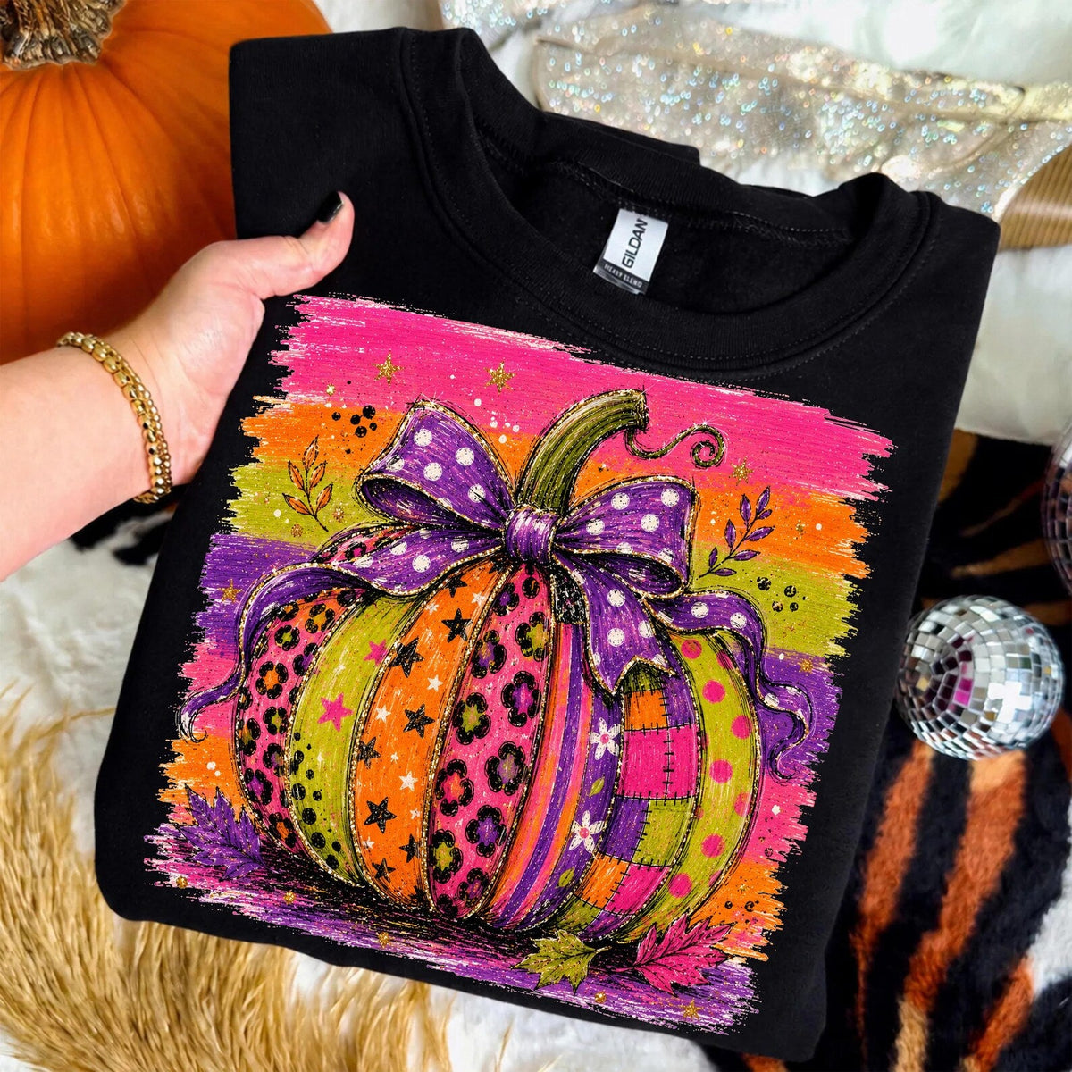 Patchwork pumpkin graphic tee by Anchored Grace Boutique, featuring a colorful fall-inspired design on a casual graphic tee.