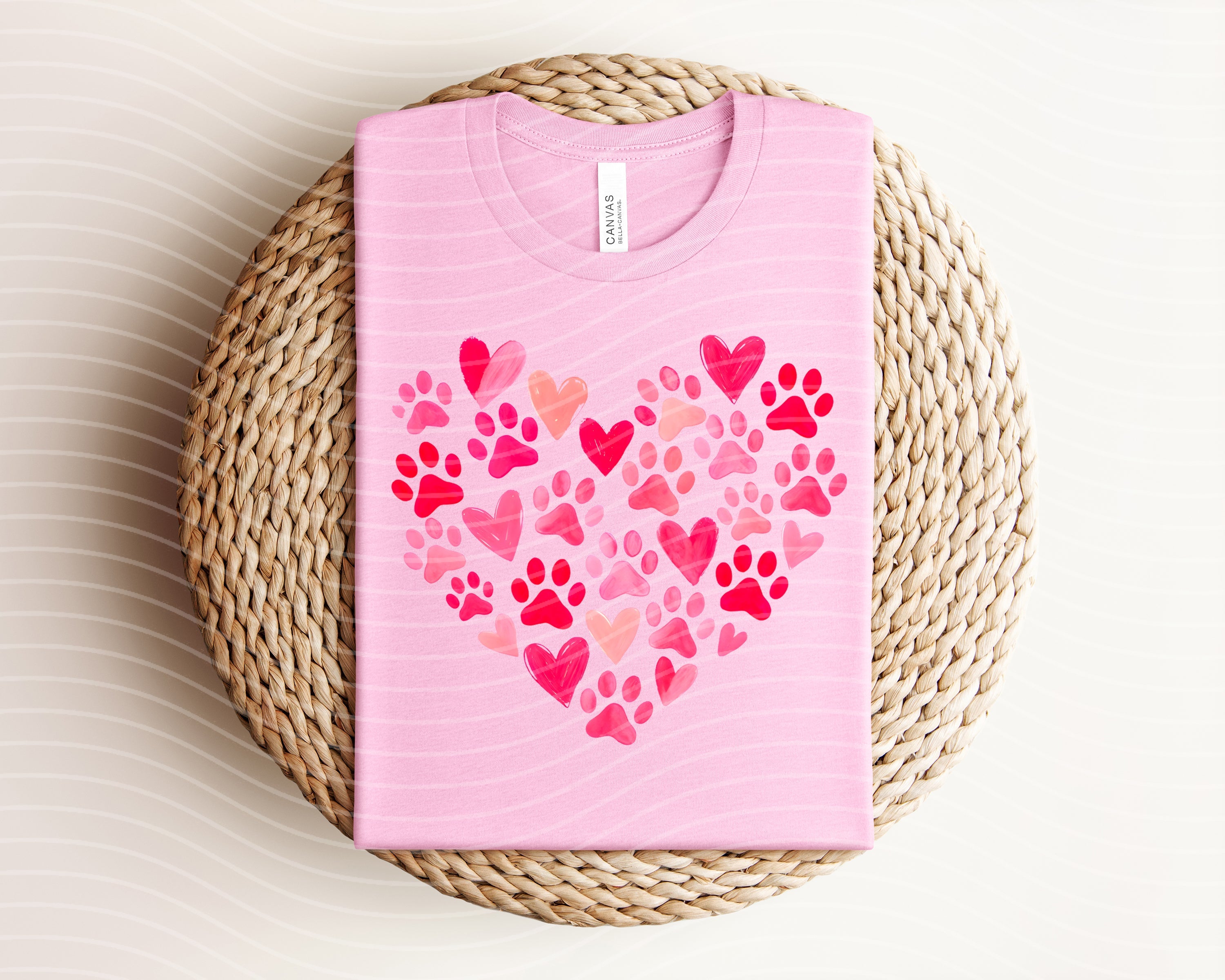 Pink graphic tee featuring a paw print heart design from Anchored Grace Boutique, casual apparel for animal lovers.