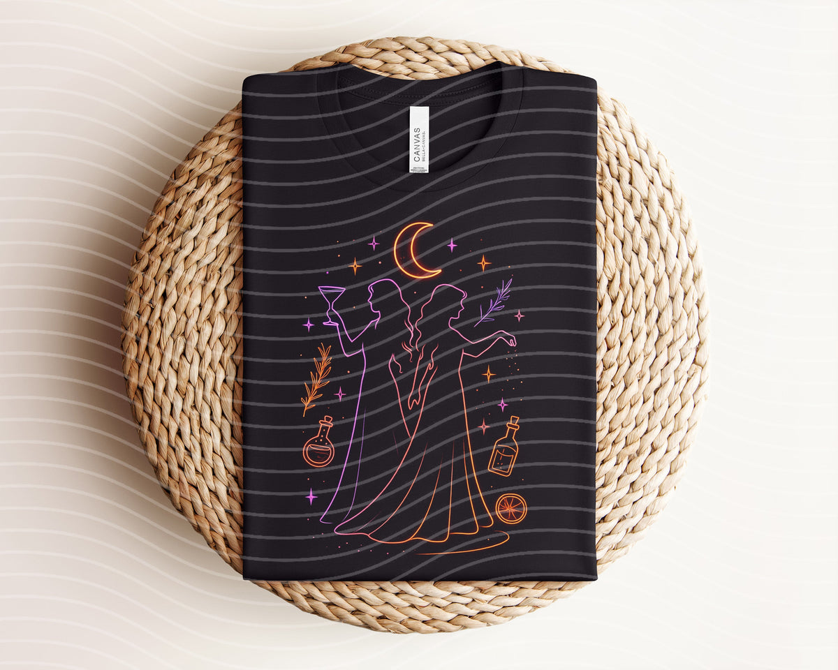 Practical Magic neon graphic tee from Anchored Grace Boutique featuring a vibrant, colorful design on a black cotton t-shirt.