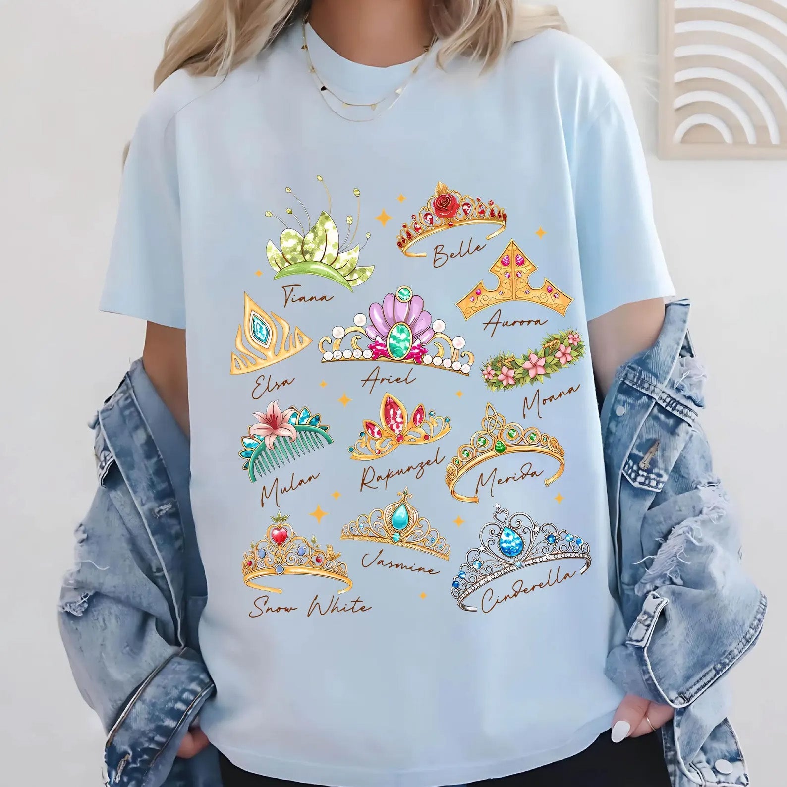 Princess Crowns graphic tee by Anchored Grace Boutique featuring a colorful crown illustration on a casual cotton shirt.