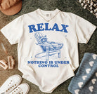 Relax Nothing is Under Control graphic tee by Anchored Grace Boutique, featuring a casual cotton t-shirt with a bold printed design.