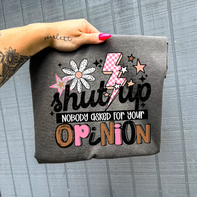 Black graphic tee from Anchored Grace Boutique with bold "Shut Up Nobody Asked for Your Opinion" text, casual fit and round neckline.