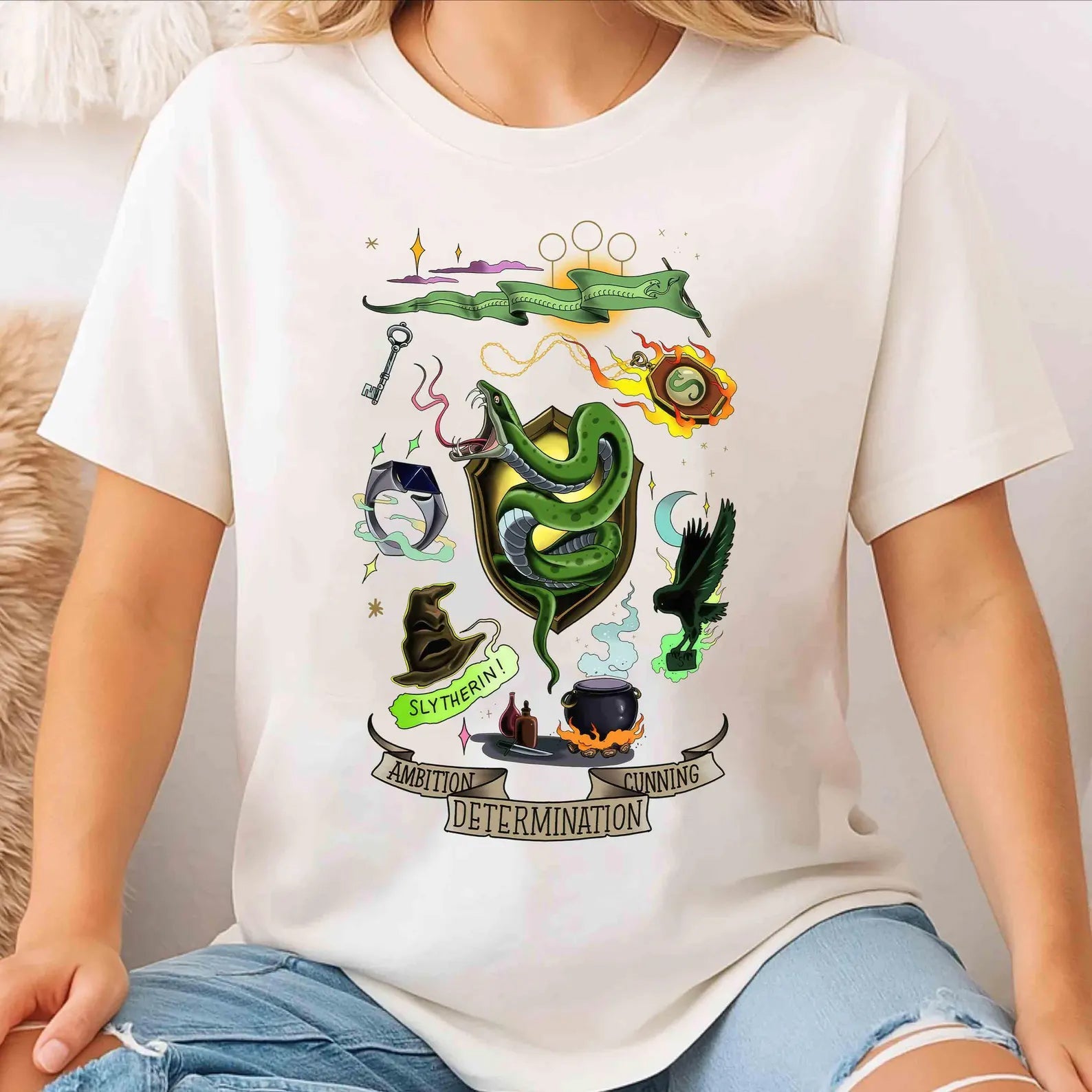 Slytherin Collage Graphic Tee by Anchored Grace Boutique featuring a detailed Slytherin house design on a casual graphic t-shirt.