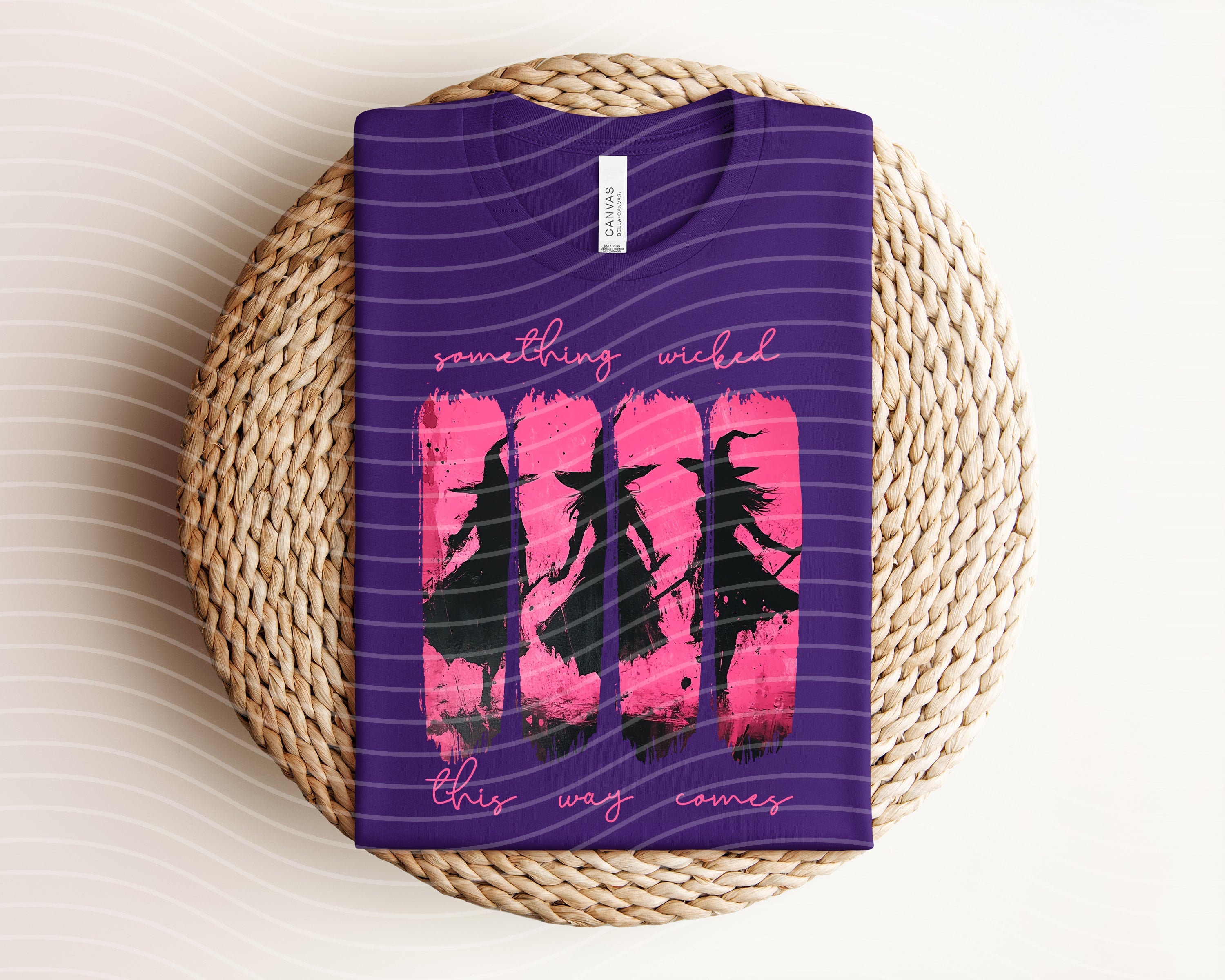 Black graphic tee by Anchored Grace Boutique featuring the phrase "Something Wicked This Way Comes" in bold white lettering.