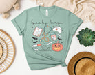 Spooky Nurse graphic tee by Anchored Grace Boutique featuring a dark, Halloween-inspired nurse design on a casual t-shirt.