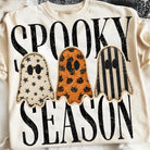 Black Spooky Season graphic tee from Anchored Grace Boutique featuring Halloween-themed designs and festive spooky graphics.