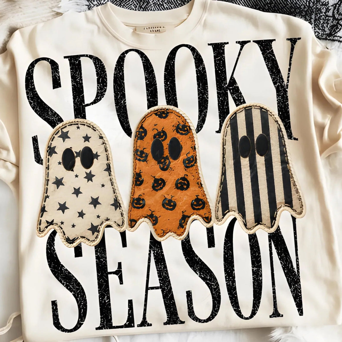 Black Spooky Season graphic tee from Anchored Grace Boutique featuring Halloween-themed designs and festive spooky graphics.
