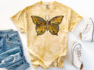Sunflower butterfly graphic tee from Anchored Grace Boutique featuring a colorful floral and butterfly design on a casual t-shirt.