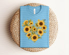 Sunflower heart graphic tee from Anchored Grace Boutique, featuring a vibrant sunflower and heart design on a casual cotton t-shirt.