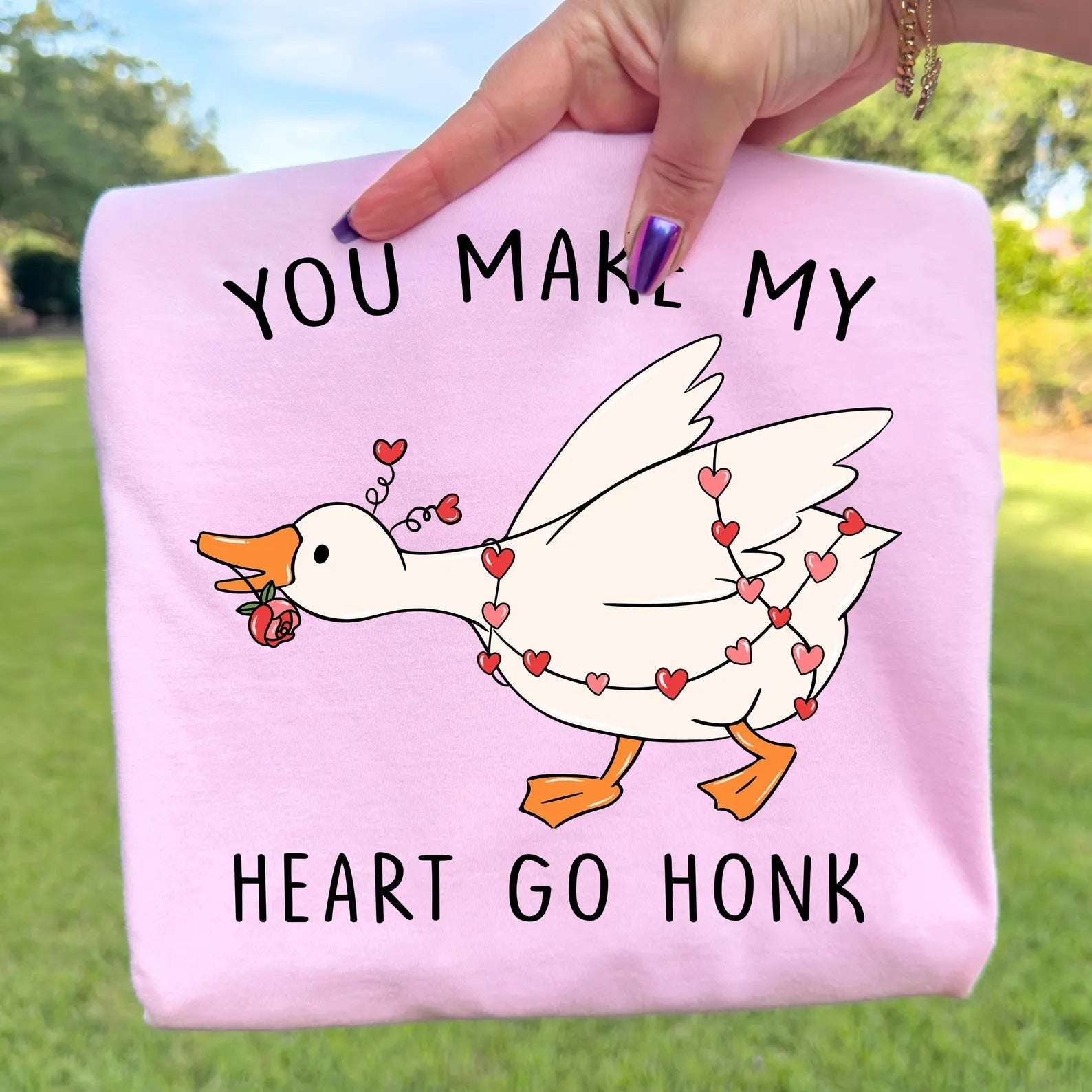 Gray graphic tee with "You Make My Heart Go Honk" text and heart design, casual style, from Anchored Grace Boutique.