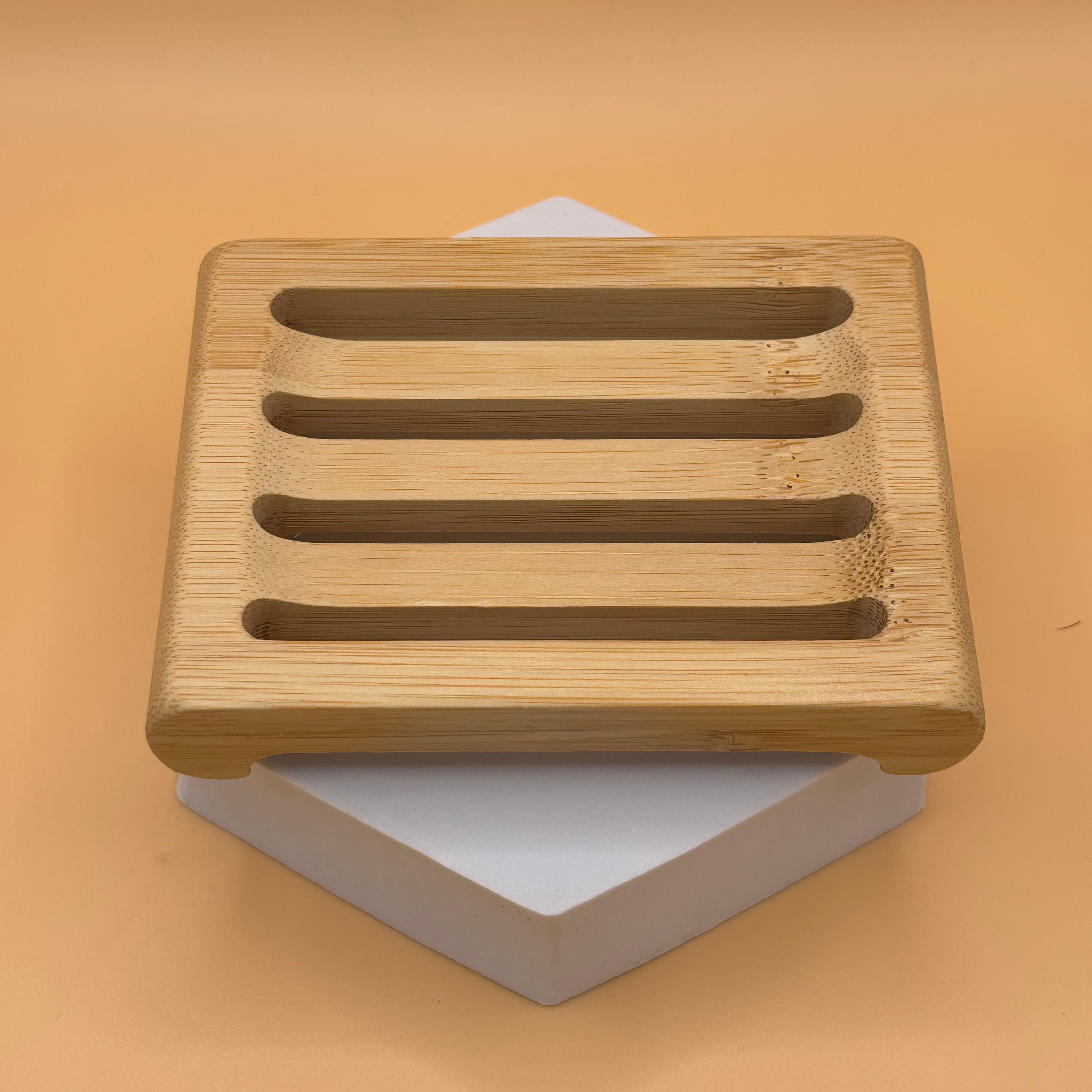 Natural bamboo soap dish from Ancient Health & Healings, featuring a sleek, eco-friendly design for organizing soap.