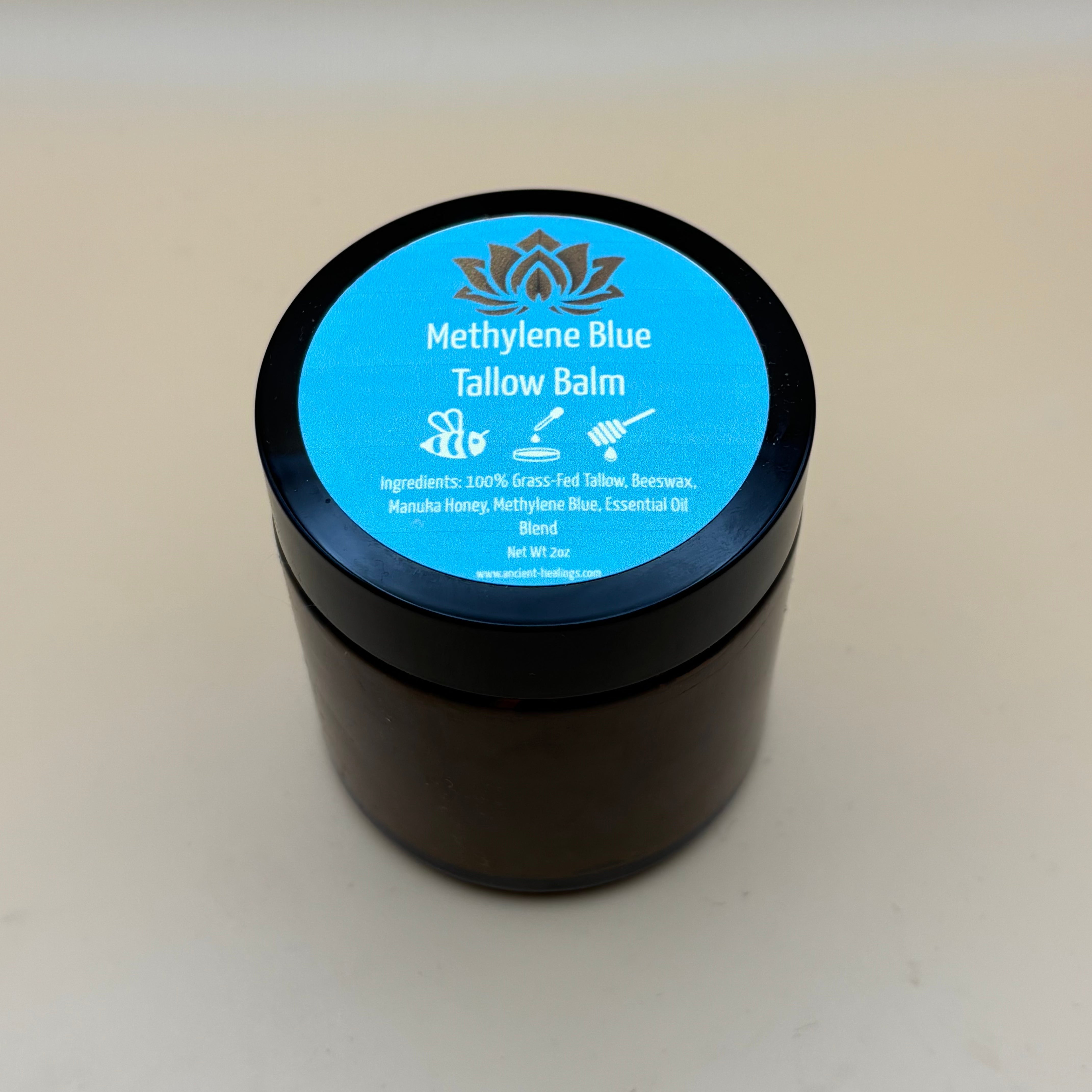 Ancient Health & Healings Methylene Blue Tallow Balm in a 2oz jar, skin care product for soothing and nourishing skin.