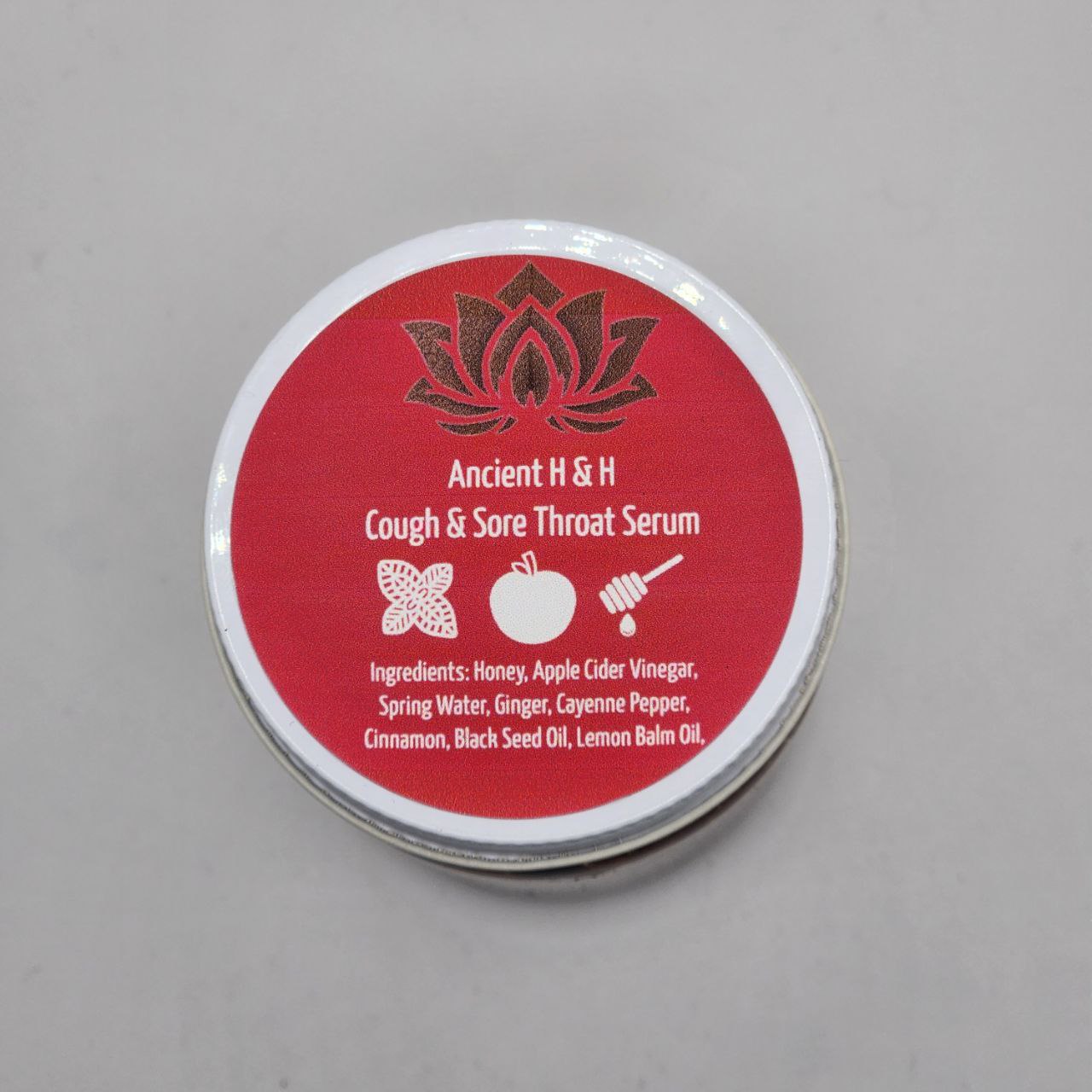 Ancient Health & Healings Cough & Sore Throat Serum supplement bottle with label and dropper cap, natural remedy for throat discomfort.