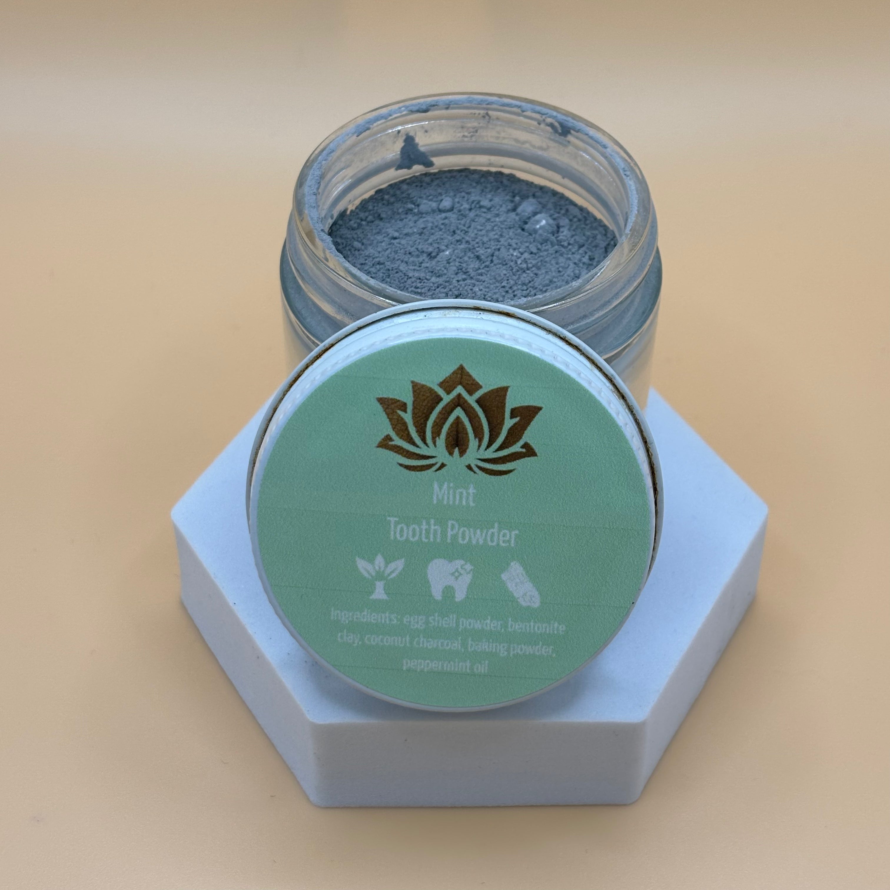 Ancient Health & Healings peppermint remineralizing toothpaste powder in a jar, showing the natural herbal formula for dental health.