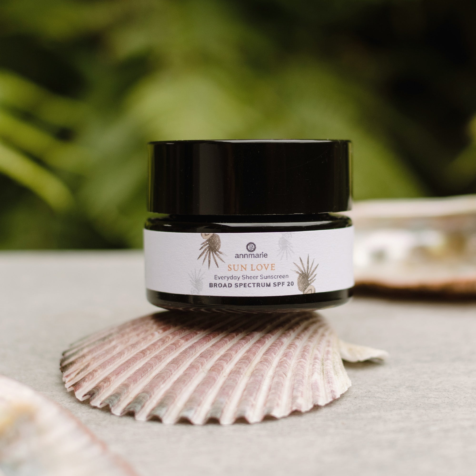 Deluxe Mini Sun Love 30ml by Annmarie Skin Care in a small, natural skincare bottle with a white cap and label.