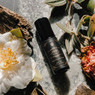 Bottle of Oud Révélé 10ml perfume by Annmarie Skin Care, featuring a sleek glass container with a black cap and elegant label.