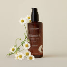 Bottle of Apoterra Vitamin C Body Oil for bath and body, unscented, with a clear label and natural ingredients visible.