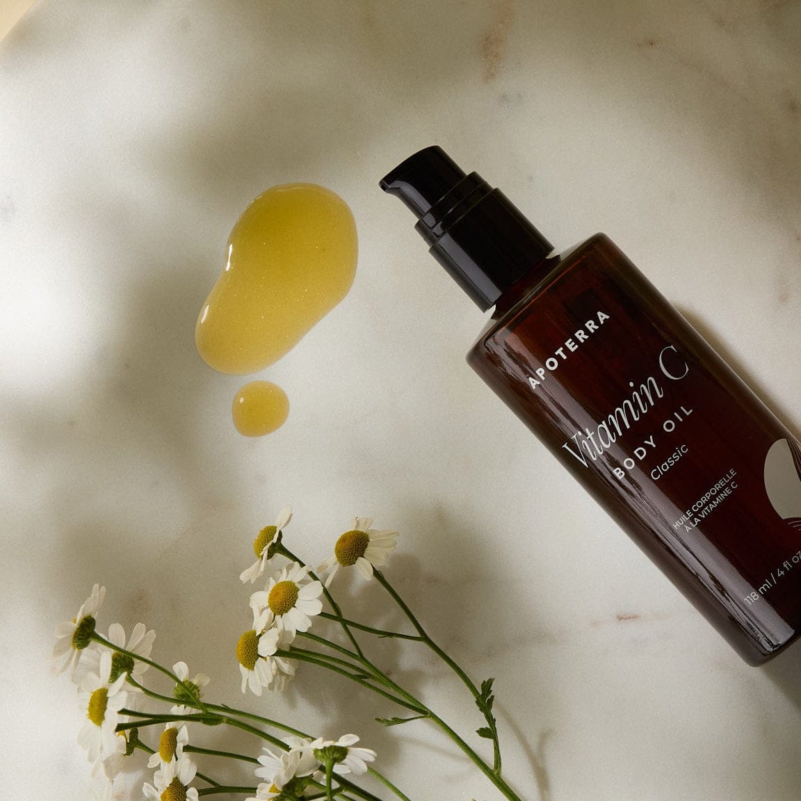 Apoterra Vitamin C Body Oil showing a classic oil texture for nourishing bath and body skincare.