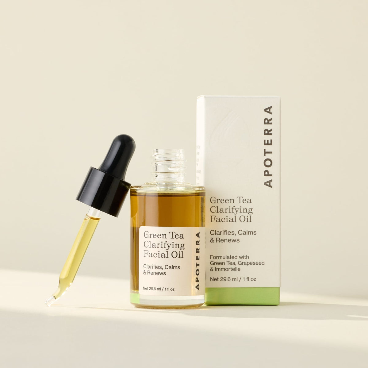 Apoterra Green Tea Clarifying Facial Oil bottle with dropper, highlighting natural ingredients for skincare.