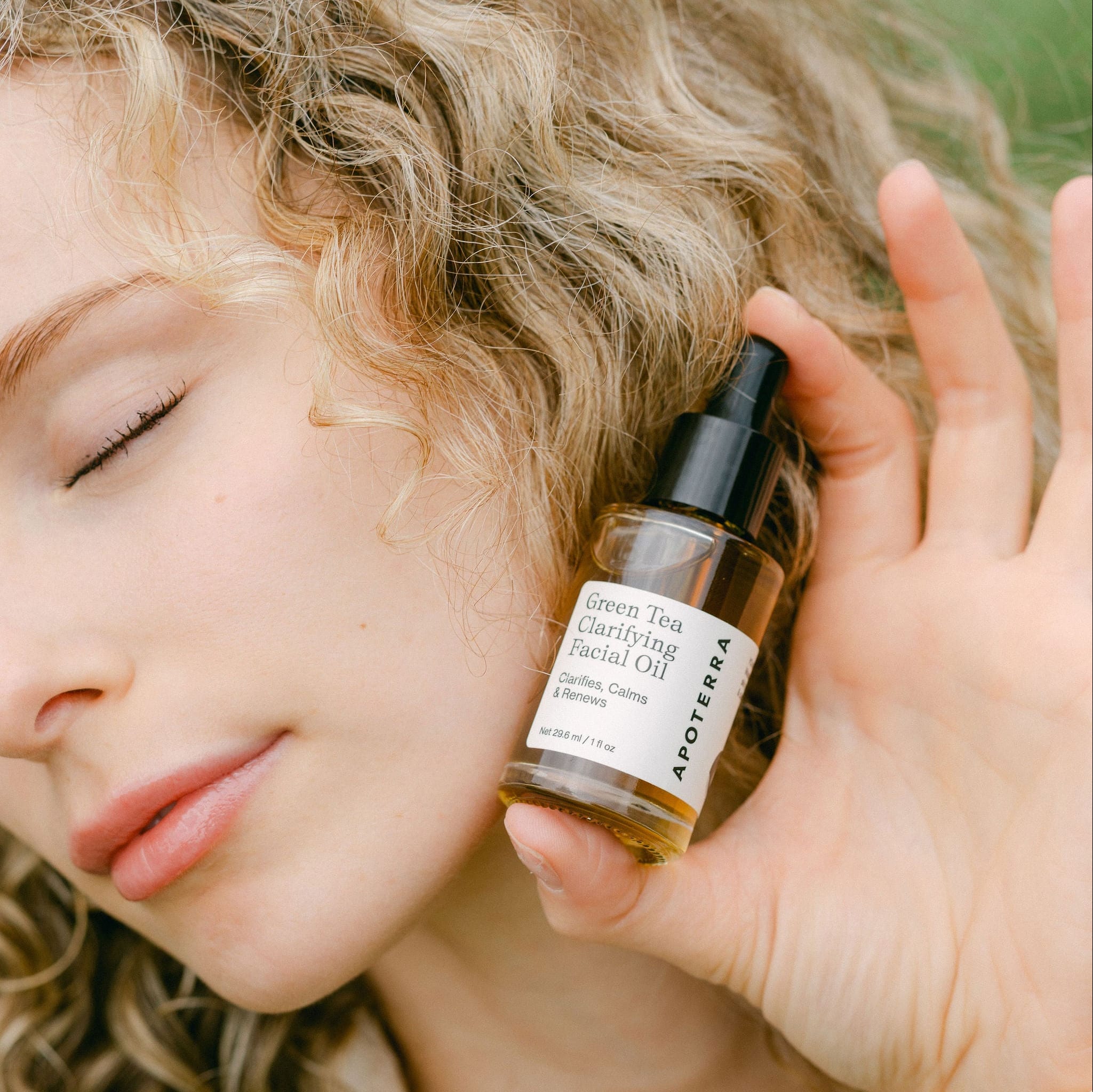 Apoterra Green Tea Clarifying Facial Oil in a glass bottle, showcasing its natural ingredients and green tea infusion.