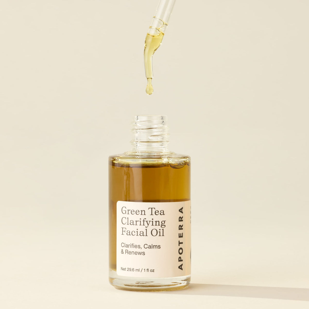 Apoterra Green Tea Clarifying Facial Oil bottle with dropper, natural herbal facial oil for skin balancing and hydration.
