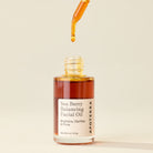 Dropper of Apoterra Sea Berry Balancing Facial Oil showing the natural oil in a glass bottle with a dropper applicator.
