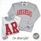 Reversible Arkansas sport grey crewneck sweatshirt by The Graphic Tee, featuring comfortable fabric and Arkansas graphic design.