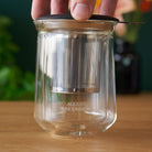 August Uncommon Tea tasting glass for tea, showcasing a clear glass vessel designed for a refined drinking experience.