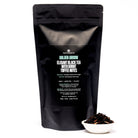 Golden Arrow Smoky Toffee Black Tea bag from August Uncommon Tea, showing the packaging with black and gold design.