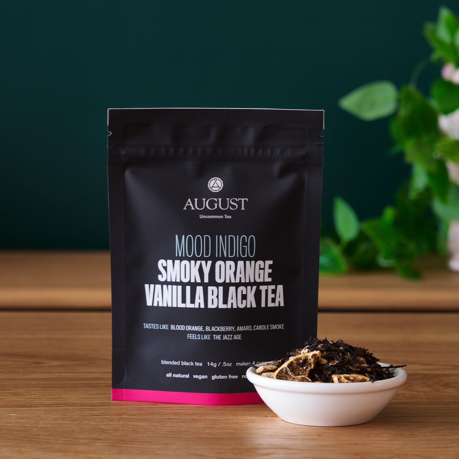 Black tea bag of Mood Indigo Smoky Orange Vanilla Black Tea by August Uncommon Tea, with vibrant orange and vanilla flavor hints