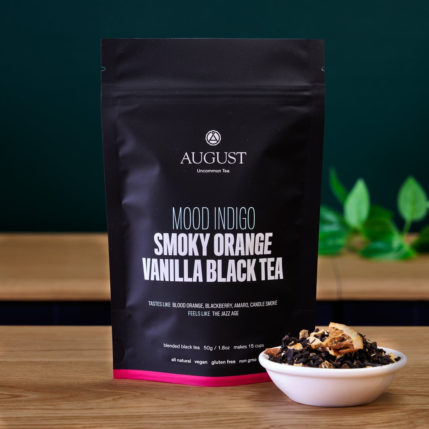 Black tea bag of Mood Indigo Smoky Orange Vanilla Black Tea by August Uncommon Tea, featuring an orange vanilla aroma.
