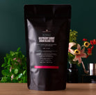 Razzmatazz Raspberry Burnt Sugar Black Tea bag from August Uncommon Tea, featuring a vibrant tea blend in a 15-cup bag.
