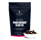 Black tea tin labeled Gold Rush Orange Rosemary Caramel Black Tea by August Uncommon Tea, showcasing the product packaging.