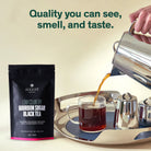 Black tea in a 28-cup tin labeled Low Country Bourbon Sugar Black Tea by August Uncommon Tea, showcasing the tea packaging.