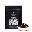 August Uncommon Passage Hazelnut Chocolate Black Tea in a 28-cup tin, featuring black tea with hazelnut and chocolate flavor.