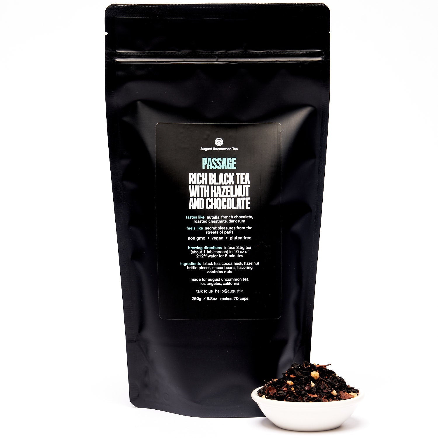 Black tea in a 28-cup tin from August Uncommon, Passage Hazelnut Chocolate Black Tea, showcasing the tea leaves and packaging.